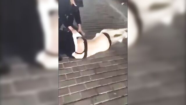 Chinese whore stripped naked in the street - 1 image