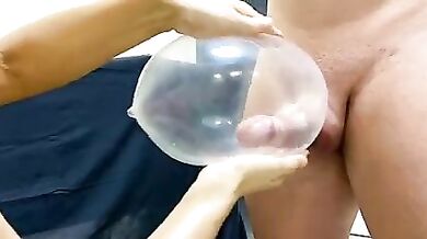 Mom is jerking son's dick with a condom